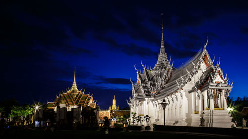 Illuminated temple building against sky at night