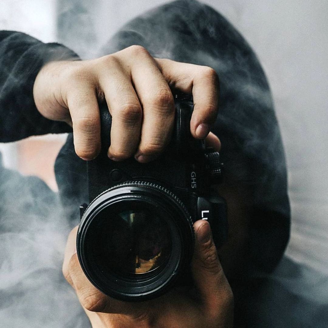 hand, one person, camera, holding, technology, close-up, adult, photographing, black, lens - optical instrument, activity, men, photographer, occupation, camera lens, indoors, person, photographic equipment, arm