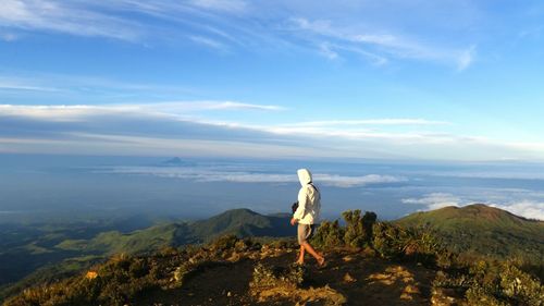 Rear view of man hiking on mount apo against sky