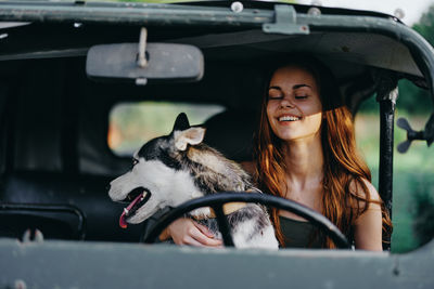 Portrait of young woman sitting in car