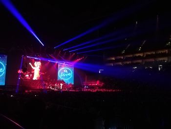 Crowd at illuminated music concert at night