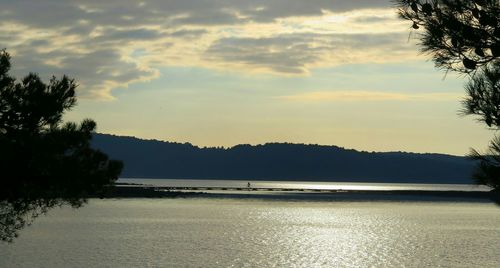 Scenic view of lake against cloudy sky