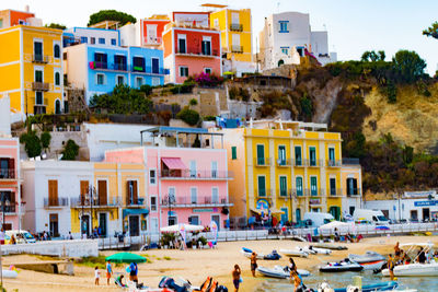 Group of people on beach against buildings in city