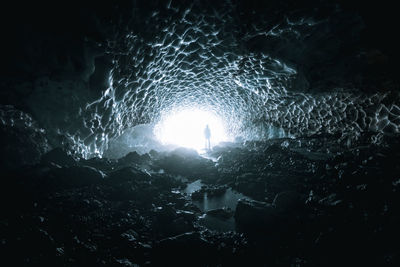 Person standing in frozen cave