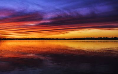 Scenic view of sea against romantic sky at sunset