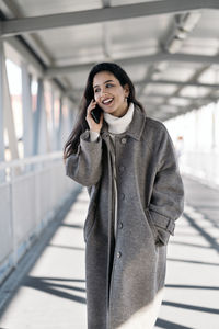Portrait of smiling young woman using smart phone