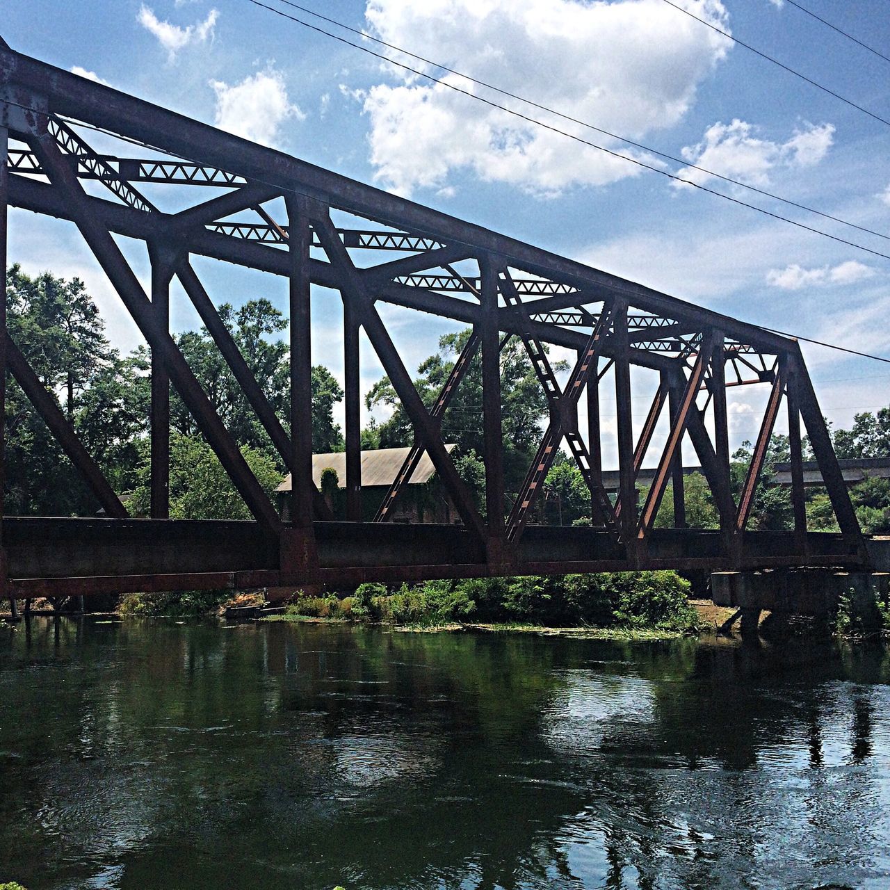 connection, bridge - man made structure, built structure, water, architecture, river, engineering, sky, bridge, low angle view, waterfront, transportation, reflection, metal, outdoors, no people, cloud - sky, day, long, nature