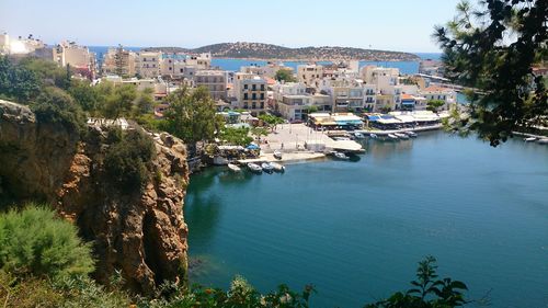 Town by sea against sky