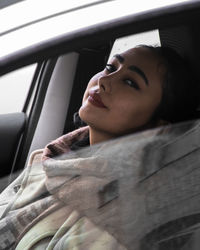 Low angle view of young woman in car