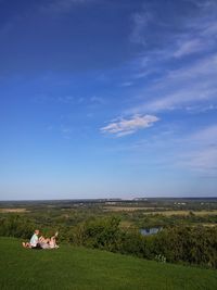 Scenic view of field against blue sky