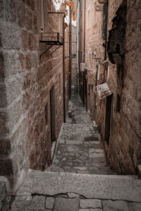 Narrow alley amidst buildings in city