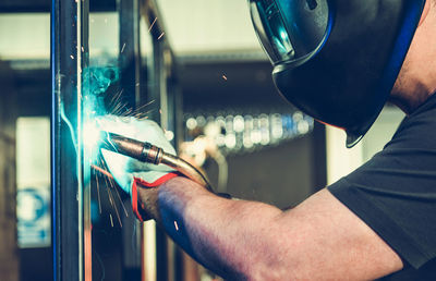 Cropped hand of man repairing car