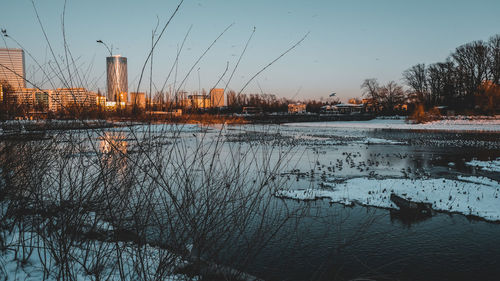 Scenic view of lake against sky during winter