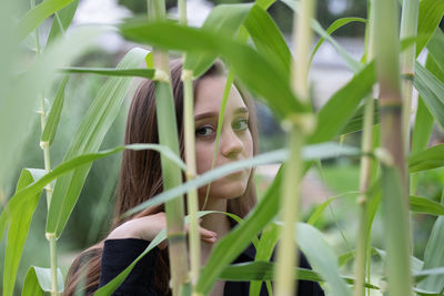 Portrait of young woman with plants