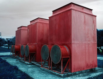 Row of train on field against sky