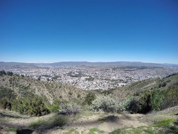 Scenic view of landscape against clear blue sky