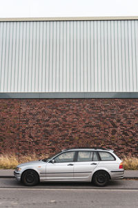 Cars parked on road against building