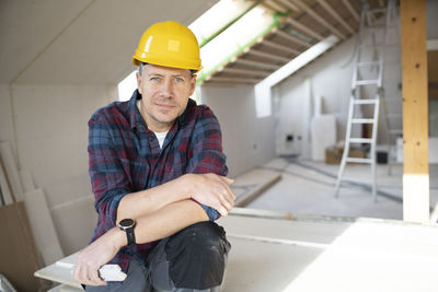 Portrait of young man working at construction site