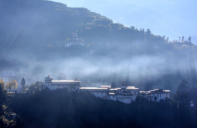 Panoramic view of trees and mountains against sky