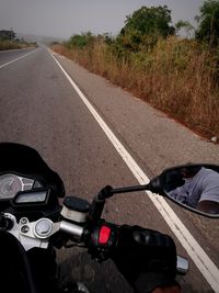 View of man riding bicycle on road