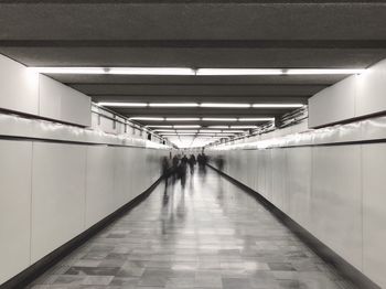 People walking in illuminated subway station