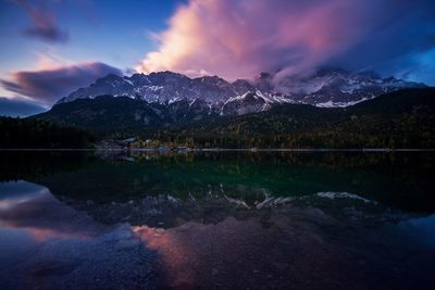 Scenic view of lake and mountains against sky during winter