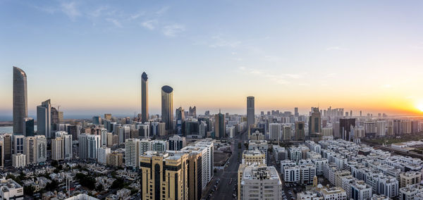 Aerial view of buildings against sky during sunset