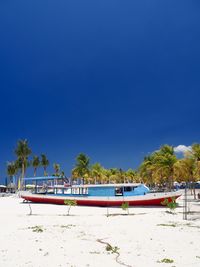 Scenic view of beach against clear blue sky