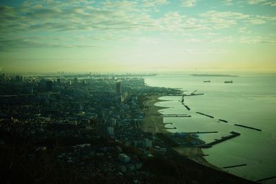 High angle view of buildings and sea against sky