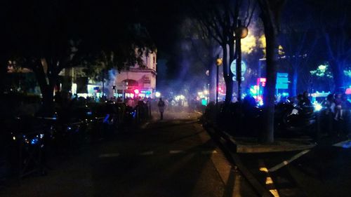 Cars on city street at night