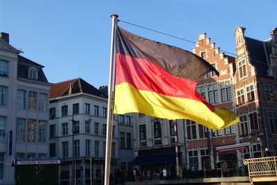 Flag of belgium in front of building