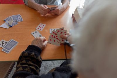 High angle view of man playing with tattoo on table