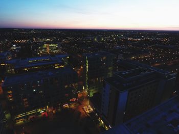 High angle view of city lit up at dusk