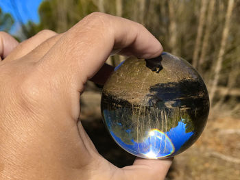 Close-up of hand holding crystal ball