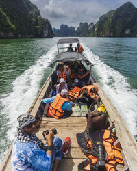 High angle view of people sitting on boat in sea