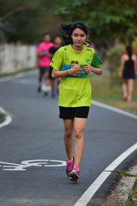 Full length of woman running on road