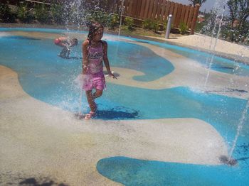 Full length of girl enjoying in swimming pool