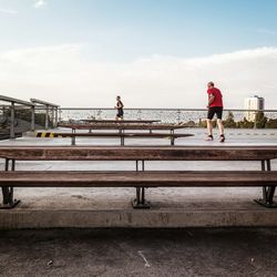 Men running against sky