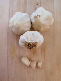 Directly above shot of garlic bulb and clove on table