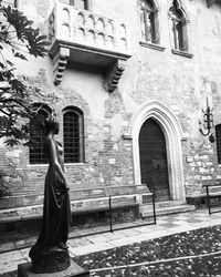 Woman standing on cross against tree