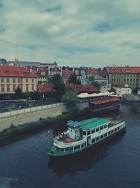 High angle view of buildings by river against sky