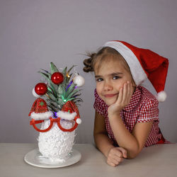 Portrait of young woman sitting on table