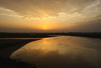 Scenic view of beach against sky during sunset