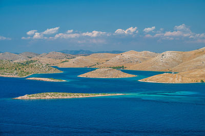Scenic view of sea and mountains against sky