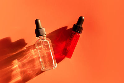 Close-up of bottles against yellow background