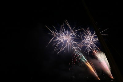 Low angle view of firework display at night