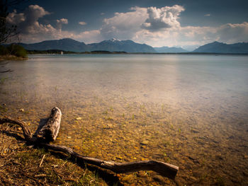 Scenic view of lake against cloudy sky