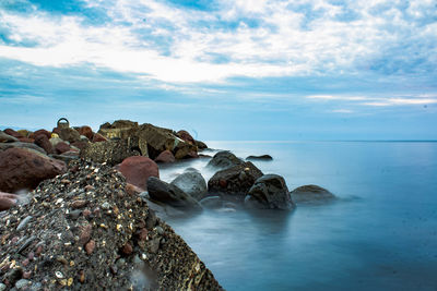 Rocks on beach against sky