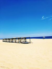 Scenic view of beach against clear blue sky