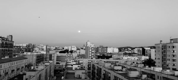 High angle view of buildings in city against clear sky